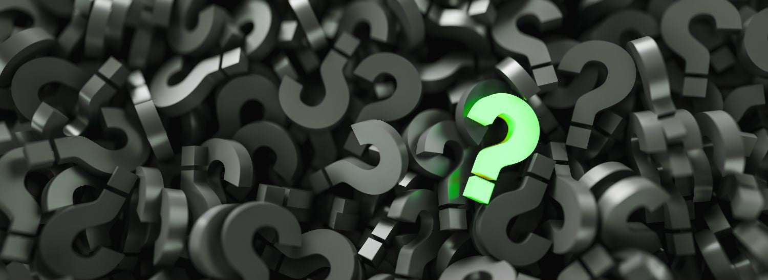 a pile of 3D question marks with a glowing lime green question mark in front