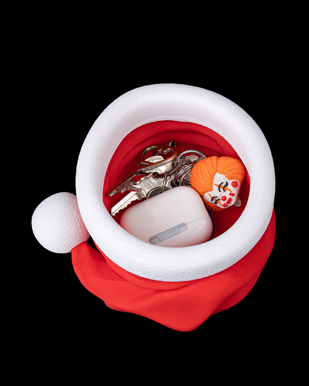 3D printed Santa’s Snack Hat Bowl filled with keys and trinkets on a black background.