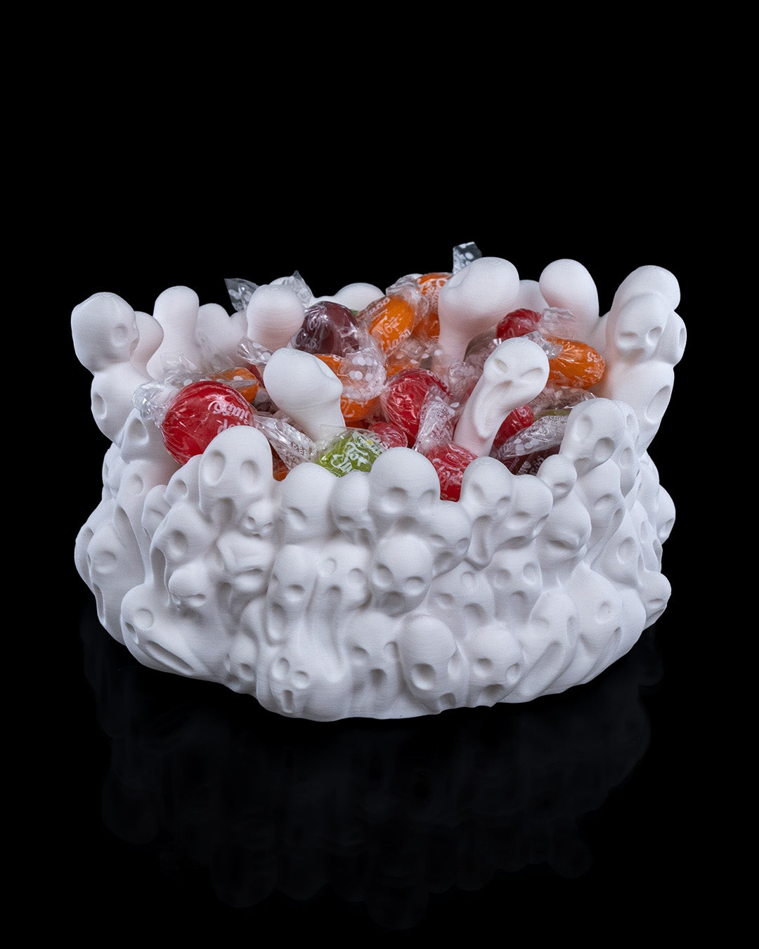 Close-up of spooky soul-themed 3D printed candy bowl filled with assorted candies, West Texas 3D printing.