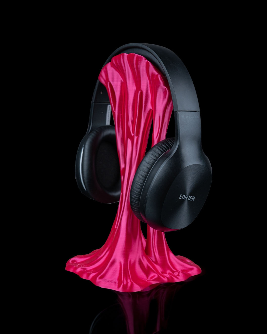 3D printed headphone holder shaped like melting slime, holding black over-ear headphones – Stick to the Beat Headphone Holder printed in west texas  by Contrive3D.