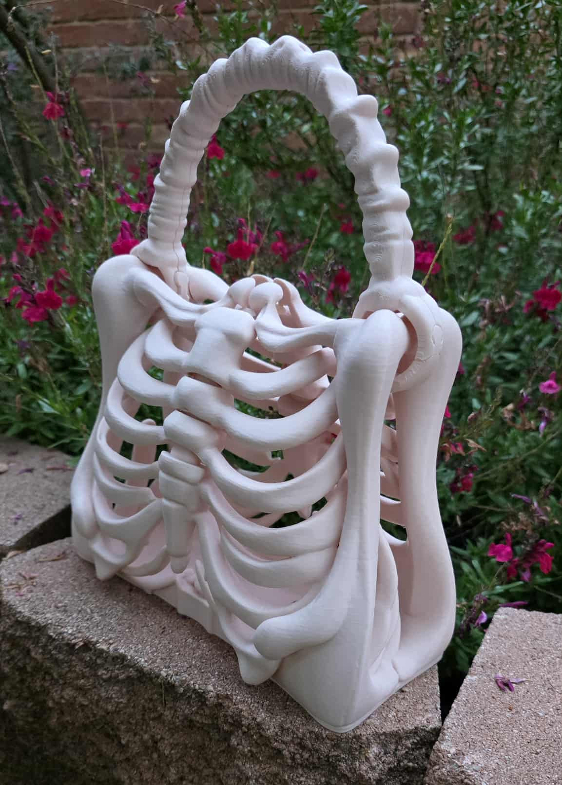 Printed by Contrive3D in West Texas - 3D printed ribcage skeleton purse with bone-style handle in beige, gothic spooky fashion accessory, approximately 9.45” x 5.51” x 11.42”