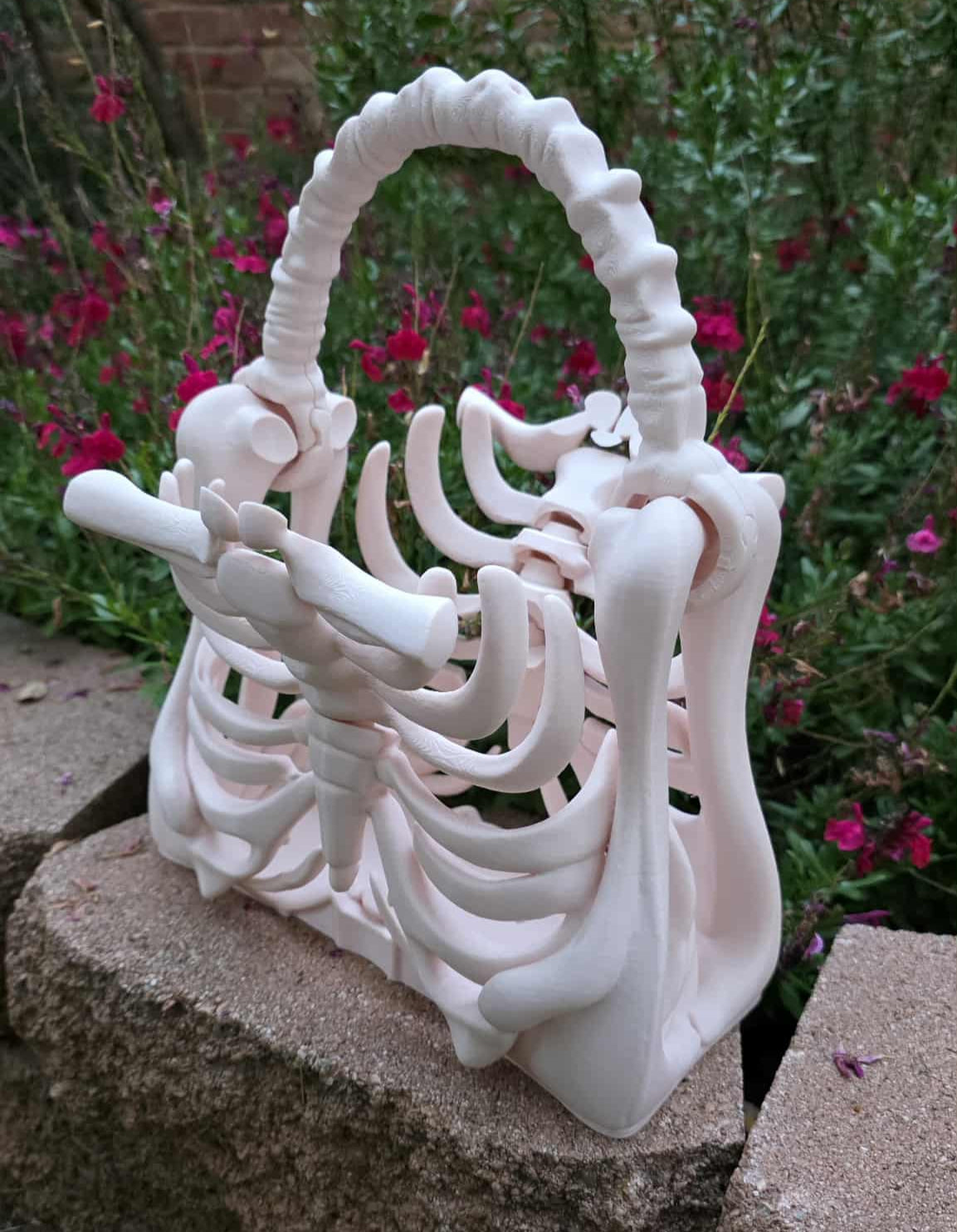 3D printed ribcage skeleton purse with bone-style handle in beige, gothic spooky fashion accessory, approximately 9.45” x 5.51” x 11.42” - printed by Contrive3D in beige PLA