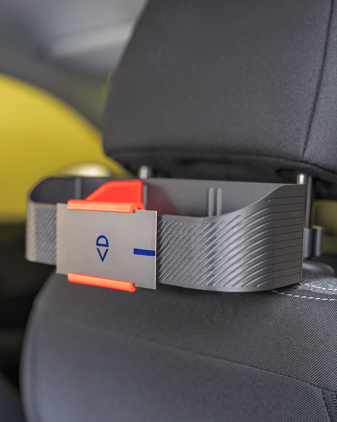 AutoEase Utility Kit tray installed on dark seat - side view