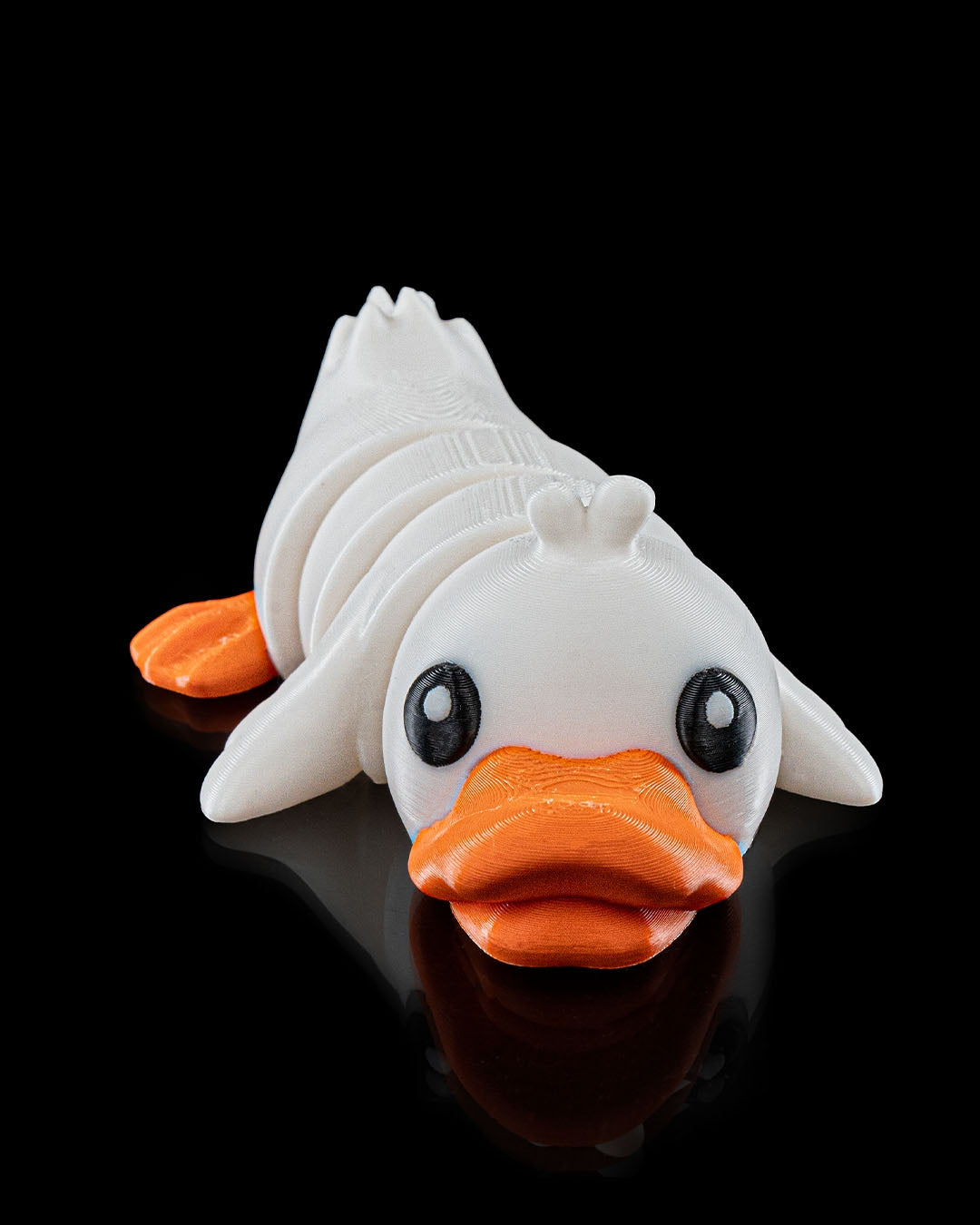 3D printed Cute Flexi Duck articulated toy in white and orange, shown from the front on a black background.