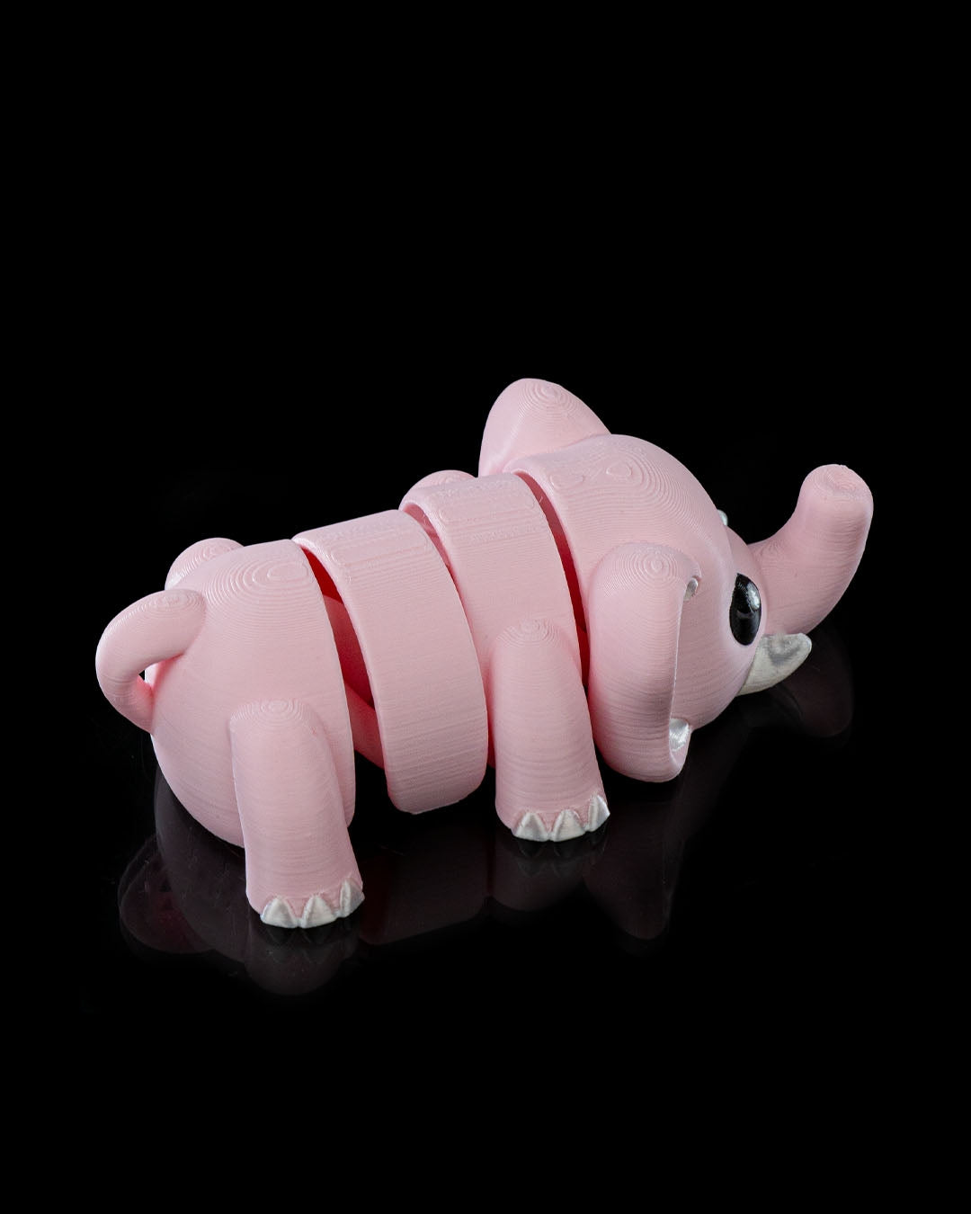 Side view of the Cute Flexi Elephant showing its flexible articulated body and trunk.