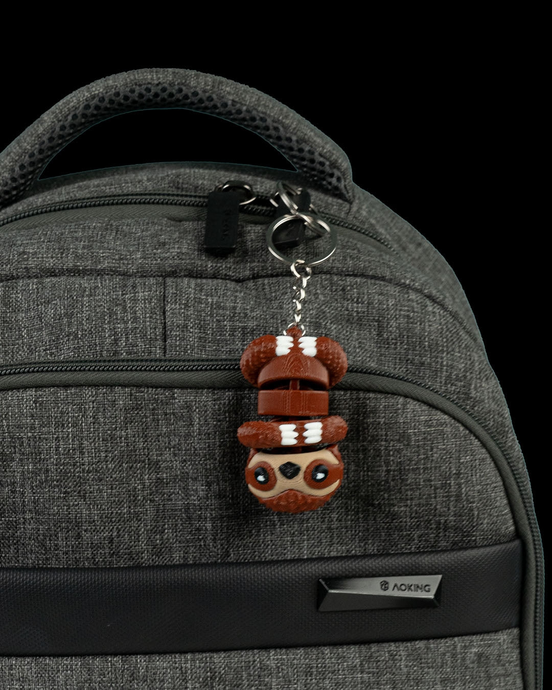 White Cute Flexi Sloth keychain attached to a backpack zipper, demonstrating size and portability.