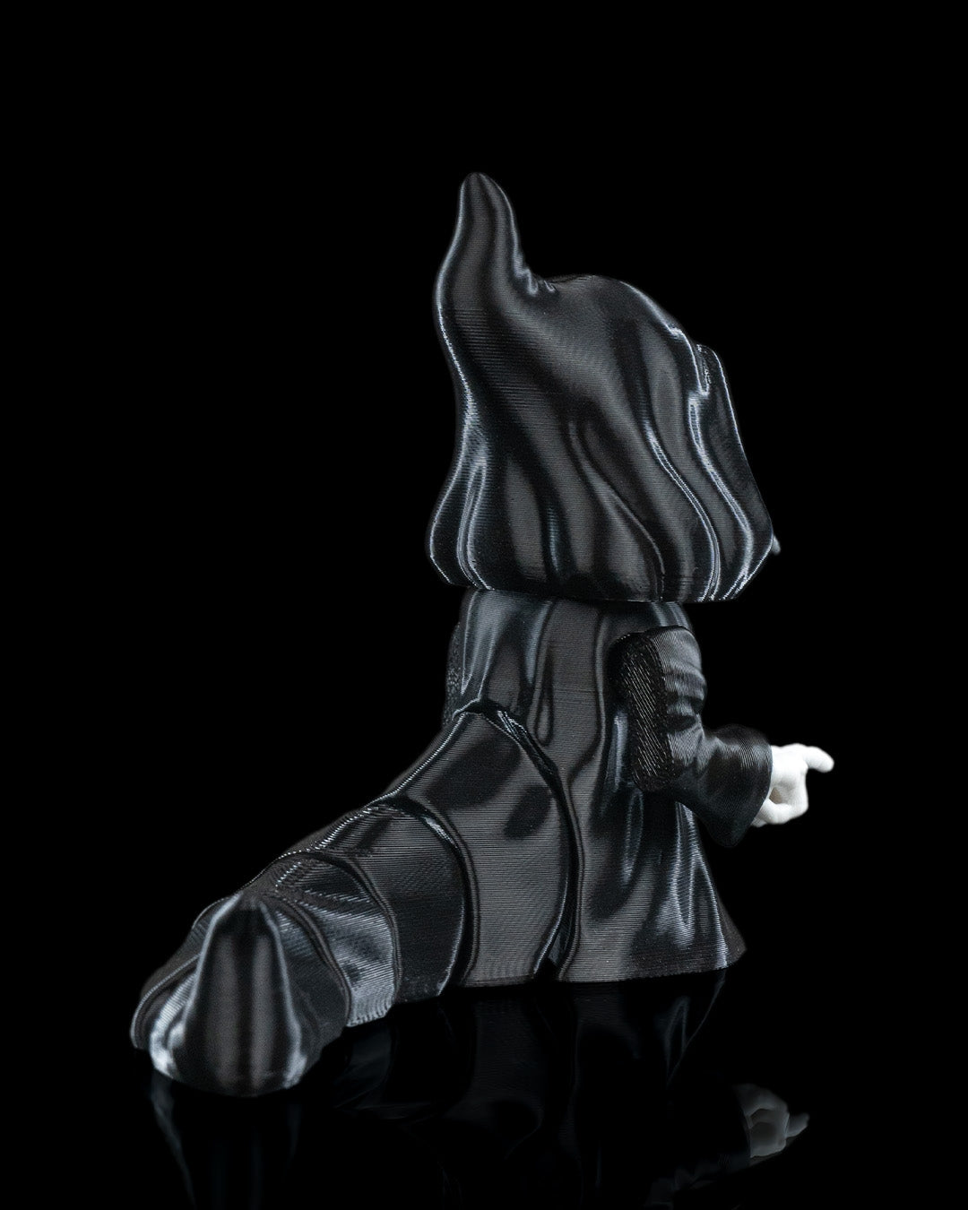 3D printed Grim Reaper flexi figurine named Death Wiggles, with skull face, hooded cloak, removable scythe, and flowing flexi cape.