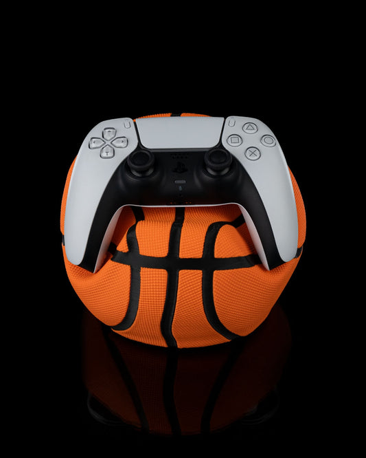 3D-printed deflated basketball controller holder with Playstation controller on top