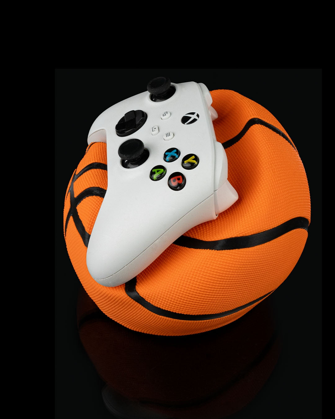 Deflated basketball controller holder for PlayStation and Xbox controllers