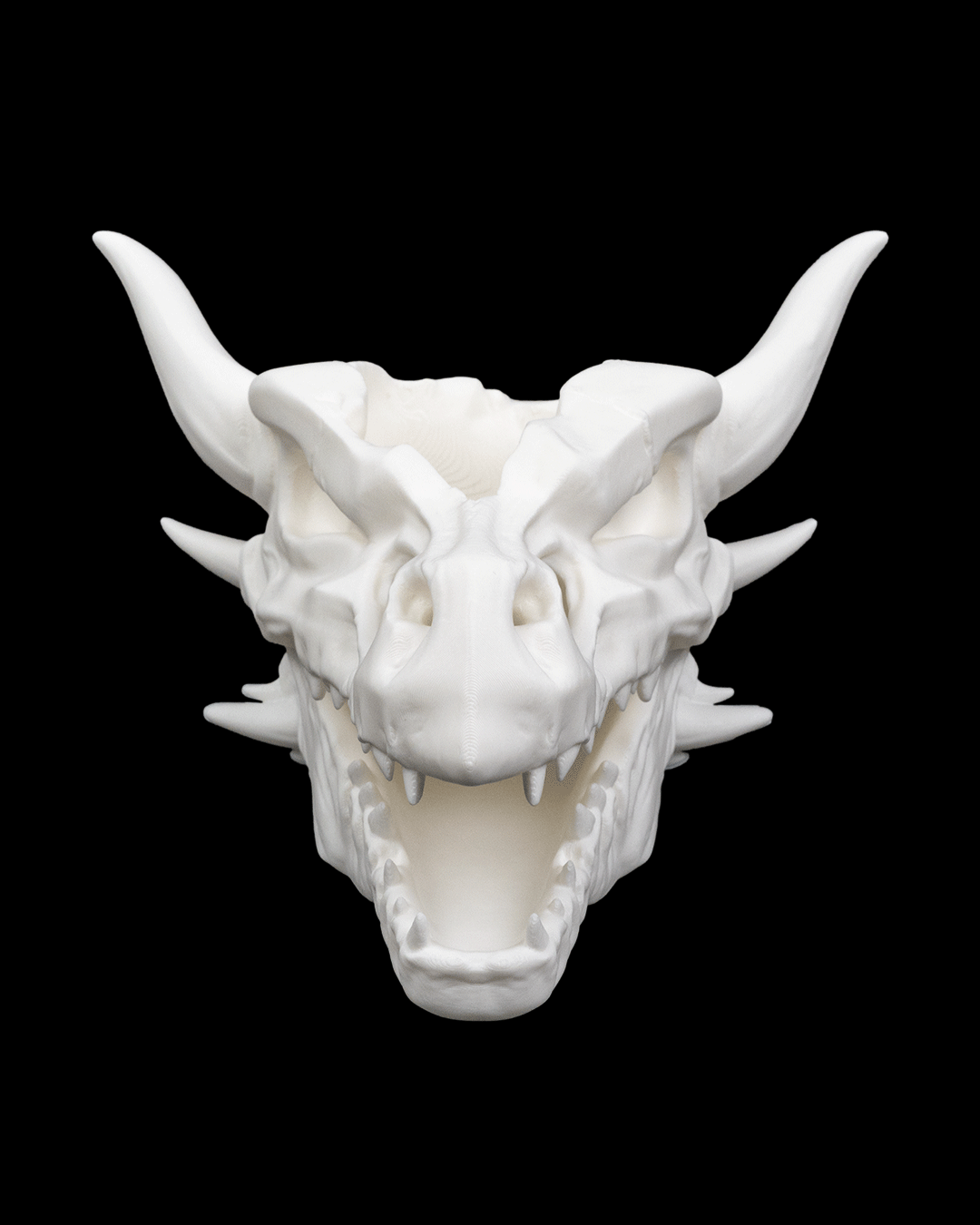 Front view of Drip & Decay gothic skull planter 17cm tall with dripping horned skull design in white