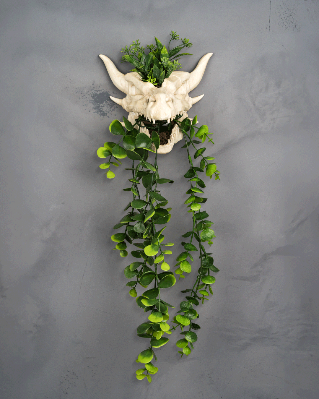Front view of Drip & Decay gothic skull planter 17cm tall with dripping horned skull design.
