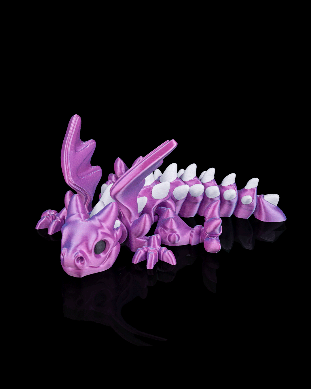 Angled view of 3D-printed Flexi Ancient Dragon displaying wings and poseable joints.
