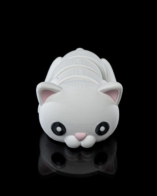 Front view of a 3D printed Flexi Cat articulated toy with white body and pink ears, lying on a reflective black surface.