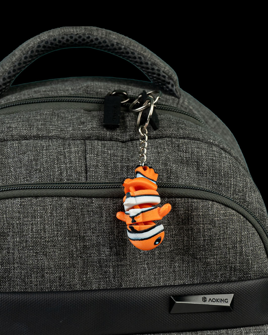 Cute flexi clownfish displayed as a keychain on a backpack