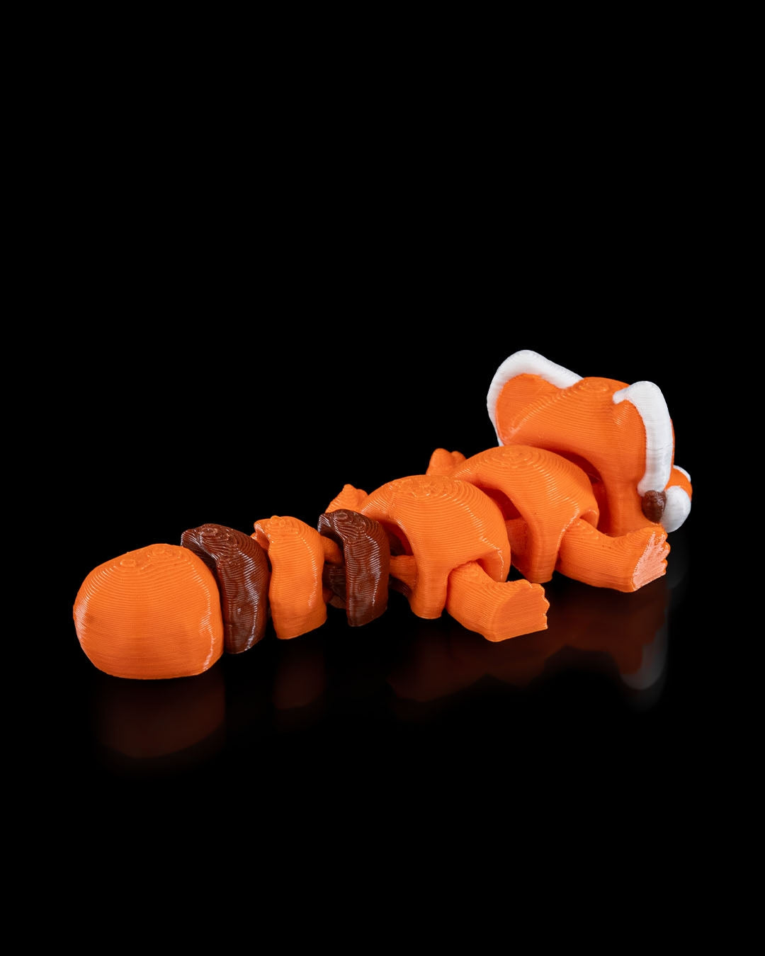 Rear angled view of a 3D printed flexi red panda showing detailed face and articulated body.