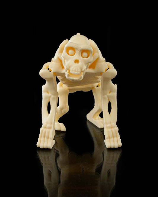 Front view of 3D printed Flexi Skeleton Chimp, articulated fidget toy standing on black reflective surface.