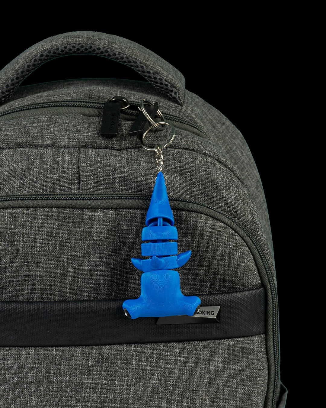 Blue flexi hammerhead shark displayed as a keychain attachment on a zipper pull.