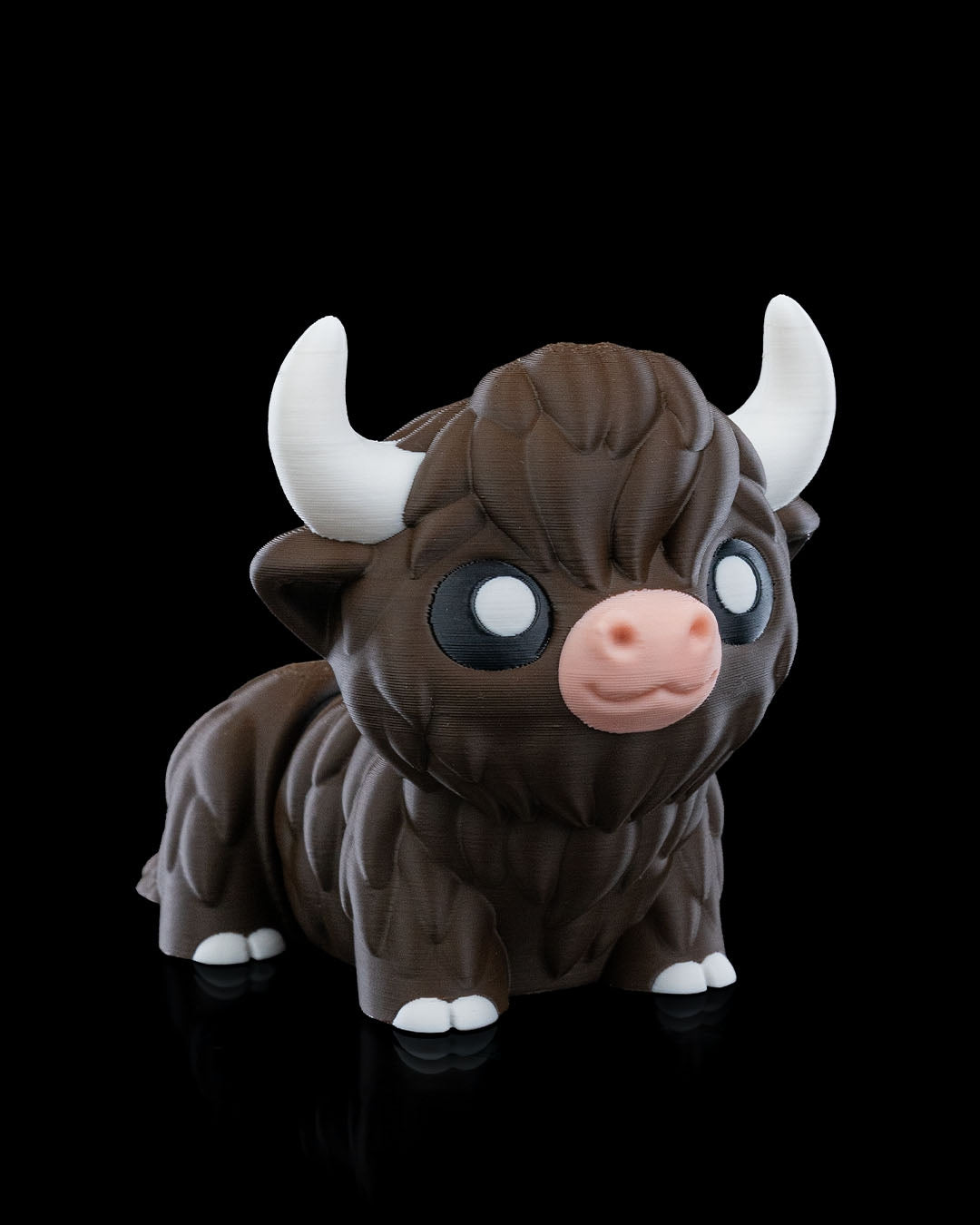 3D printed articulated Highland Cow figure, angled front view, approximately 10cm tall, with detailed fur texture and white horns.