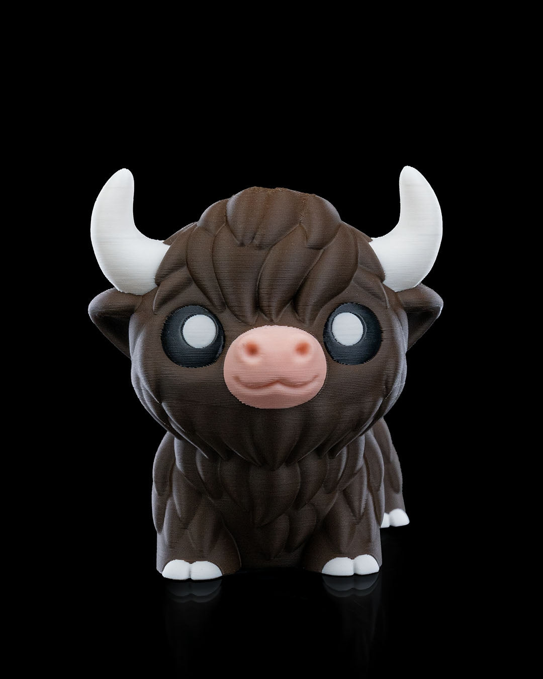 3D printed articulated Highland Cow figure, front view, approximately 10cm tall, with detailed fur texture and white horns.