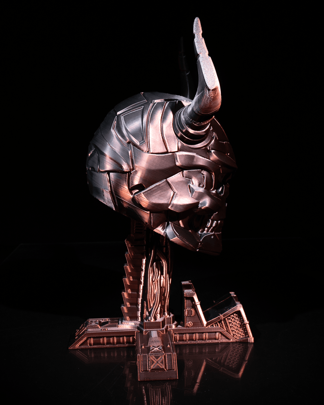 Side profile of Horned Skull stand holding headphones and gaming controller.