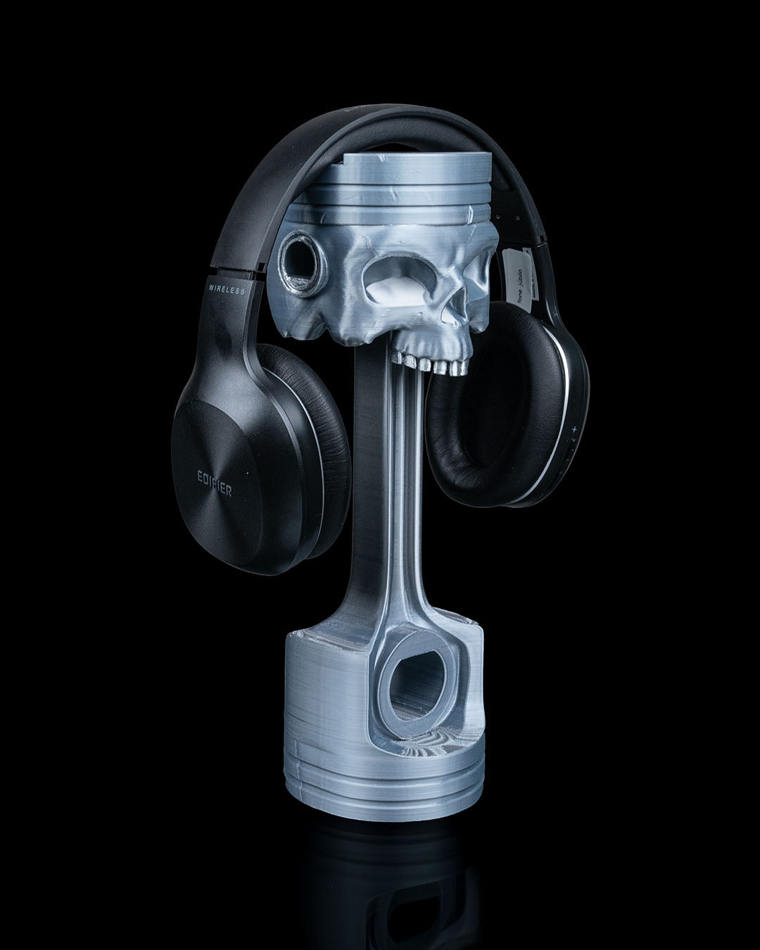 Side profile of Piston Skull Headphone Stand with piston base and skull detail.