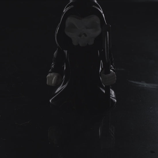 video of 3D printed Grim Reaper flexi figurine named Death Wiggles, with skull face, hooded cloak, removable scythe, and flowing flexi cape.