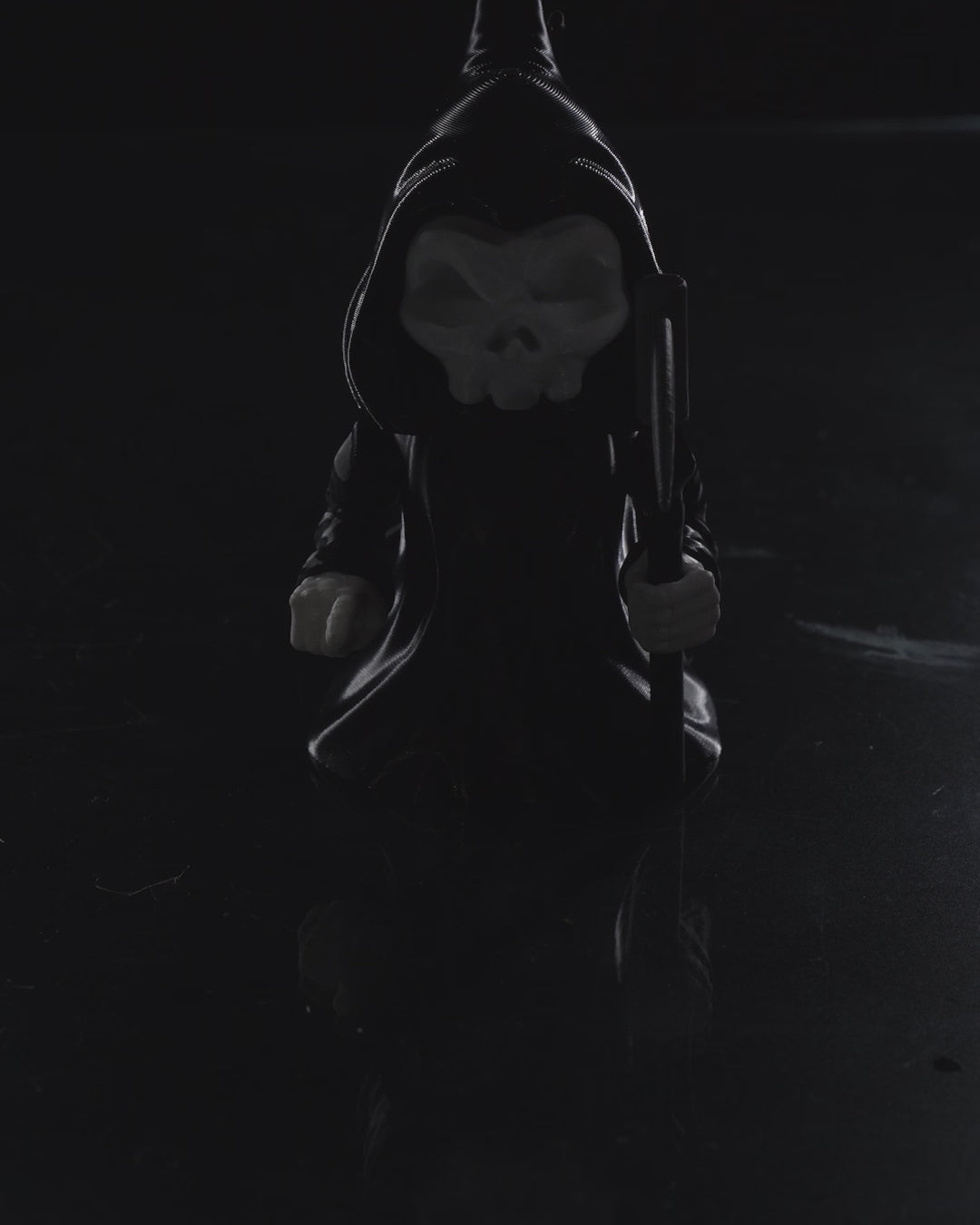 video of 3D printed Grim Reaper flexi figurine named Death Wiggles, with skull face, hooded cloak, removable scythe, and flowing flexi cape.