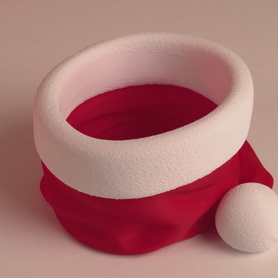 Rotating video of 3D printed Santa’s Snack Hat Bowl showing details of the festive candy dish from all sides.