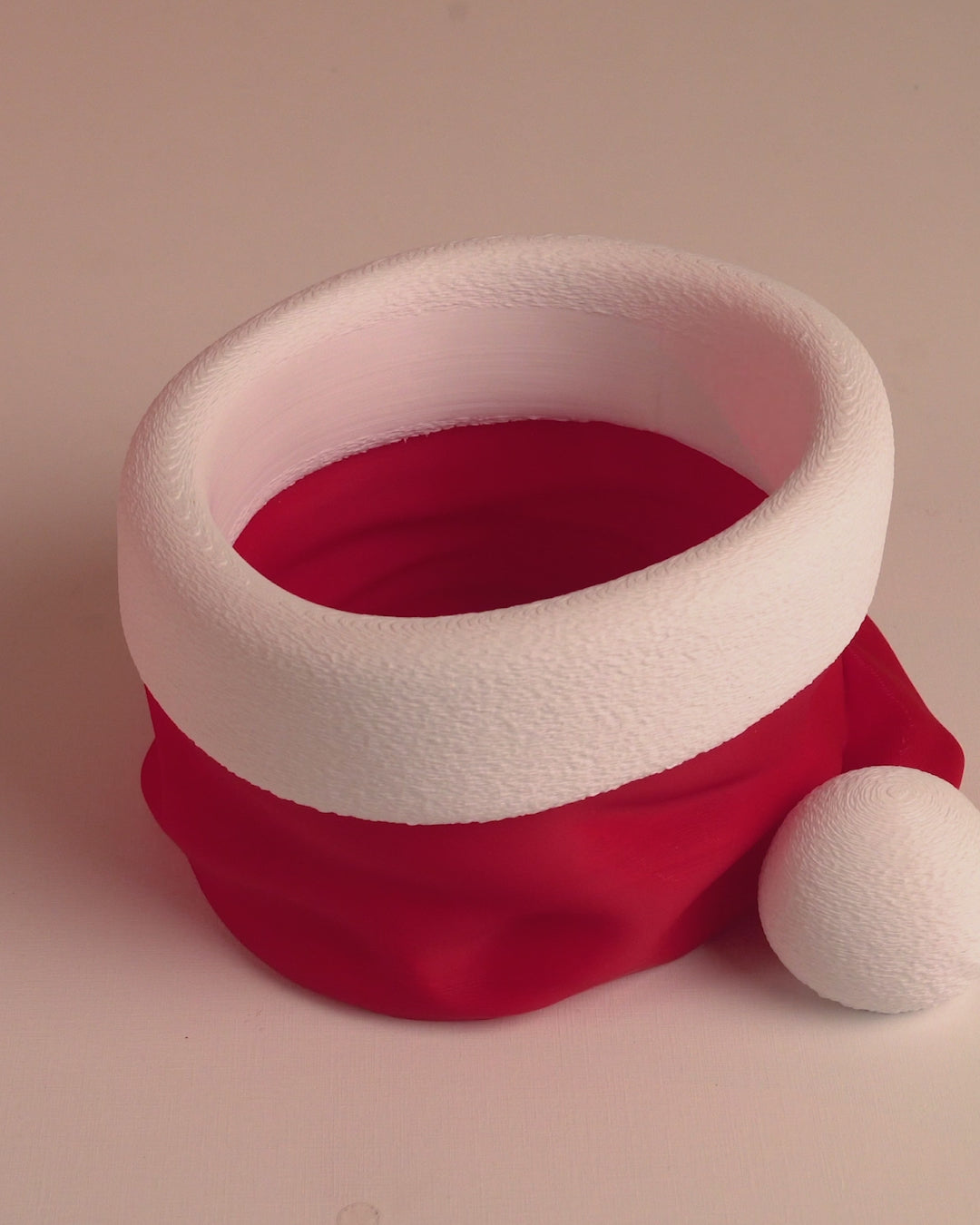 Rotating video of 3D printed Santa’s Snack Hat Bowl showing details of the festive candy dish from all sides.
