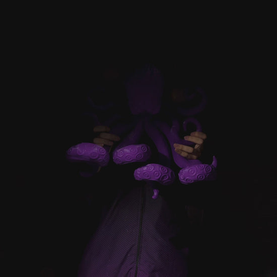 360 view of purple Octopus tentacles holding a gaming controller.