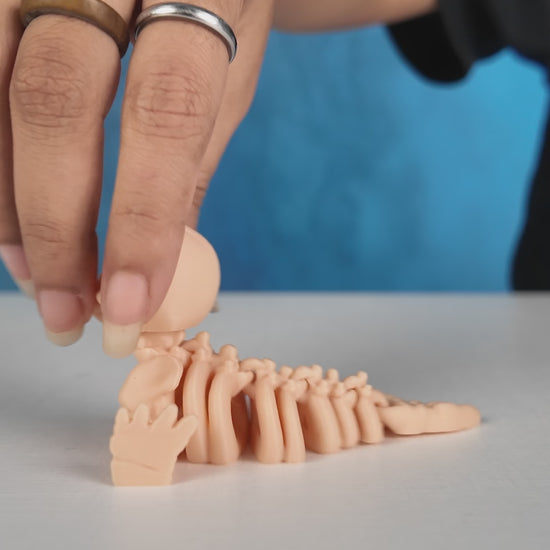 360-degree rotating view of Skeleton Fidget Seal 3D printed toy in beige PLA.