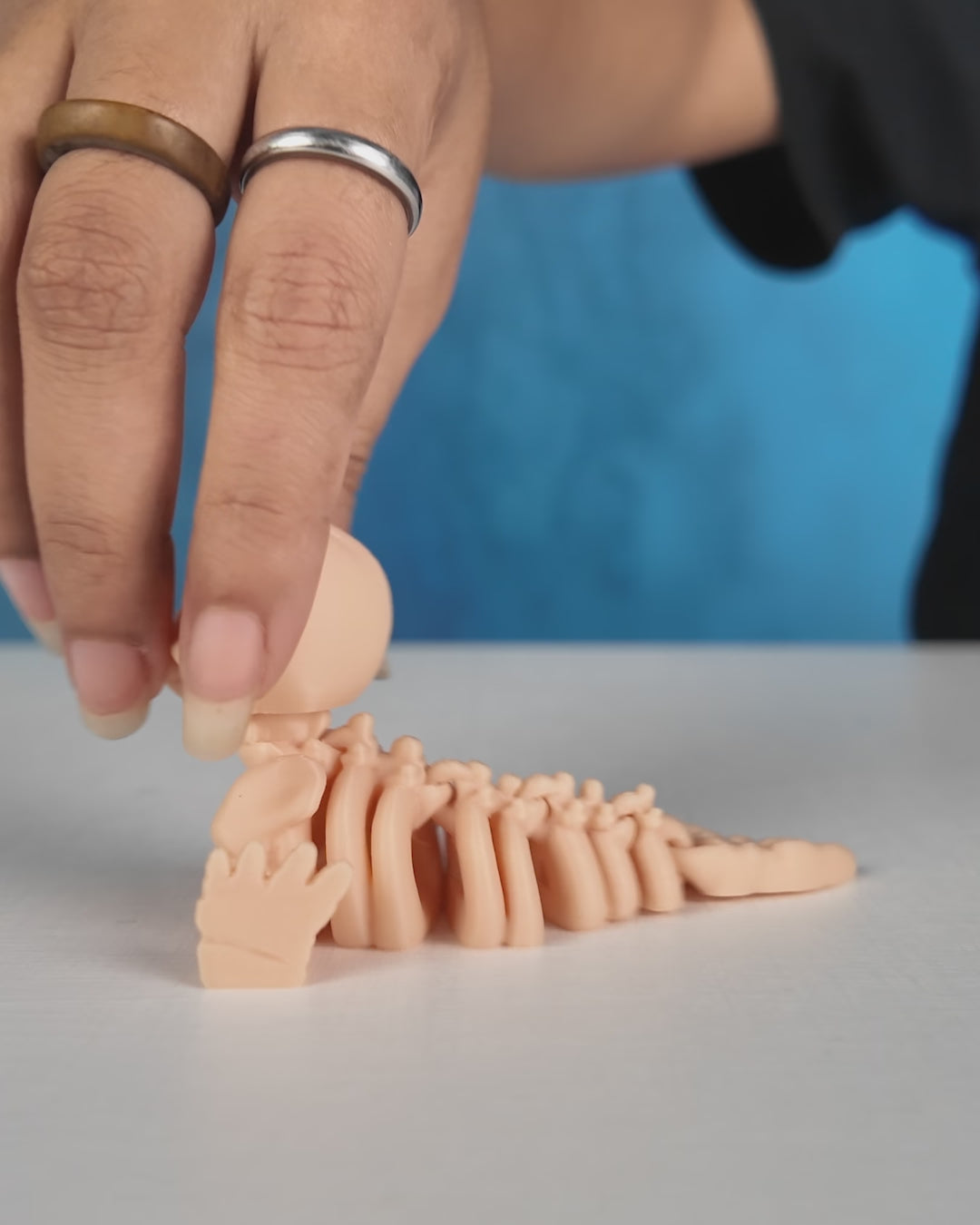 360-degree rotating view of Skeleton Fidget Seal 3D printed toy in beige PLA.