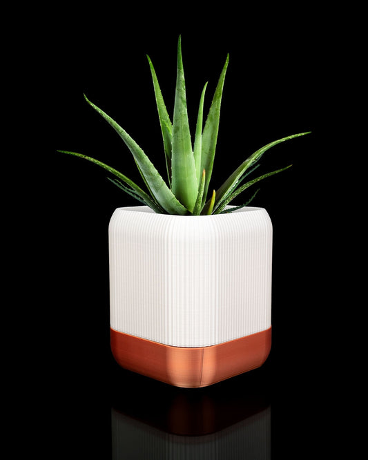 QUADRA self-watering planter in white and brown showing modern PETG indoor plant pot design with plant inside