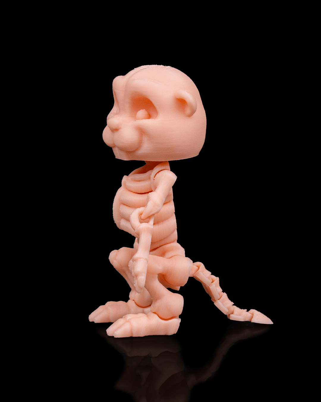 Side profile of Skeleton Fidget Beaver 3D print in beige PLA showing skeletal details and tail