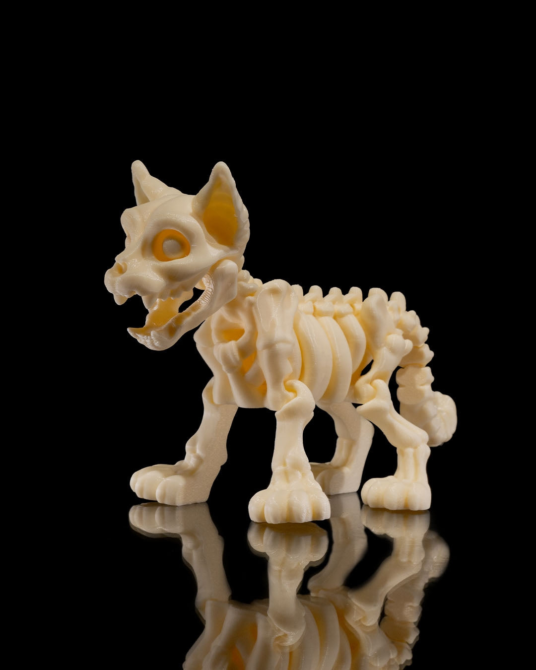 Side angled profile of Skeleton Fidget Cat 3D print in beige PLA showing tail and skeletal details.