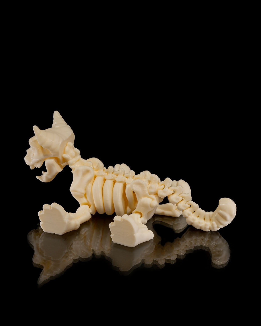 flat profile of Skeleton Fidget Cat 3D print in beige PLA showing tail and skeletal details.