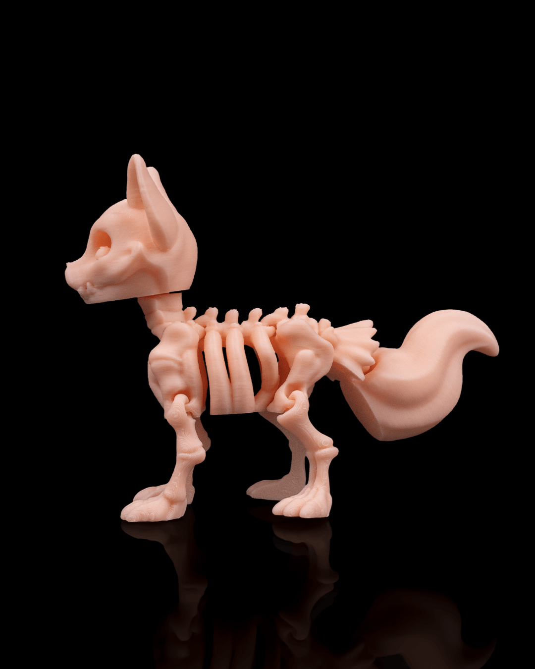 Side profile of Skeleton Fidget Fox 3D print in beige PLA showing skeletal body and tail.