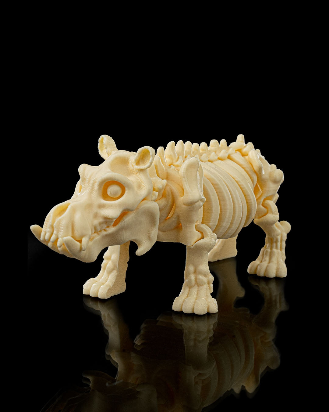 Side profile of Skeleton Fidget Hippo 3D print in beige PLA showing detailed ribs and limbs.