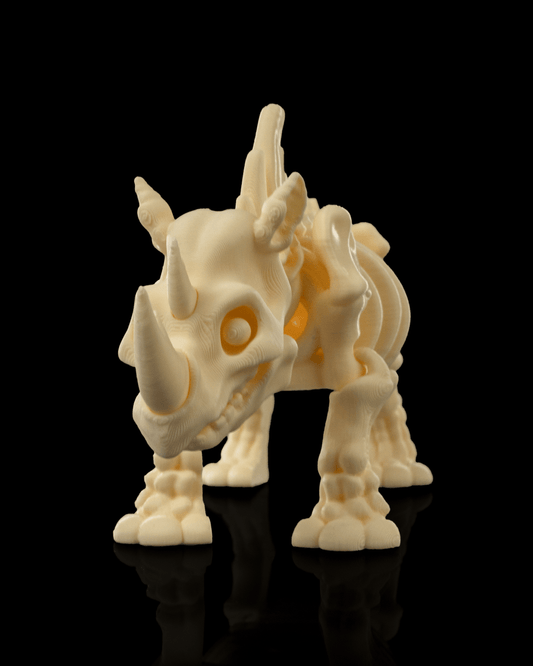Front view of 3D printed Skeleton Fidget Rhino in beige, articulated and standing on reflective black surface.
