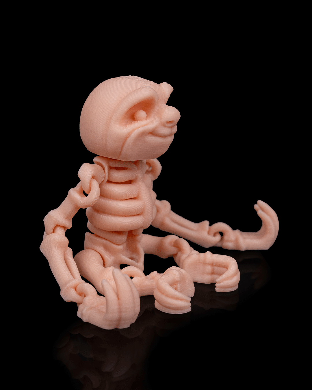 Side profile of Skeleton Fidget Sloth 3D print in beige PLA showing skeletal details