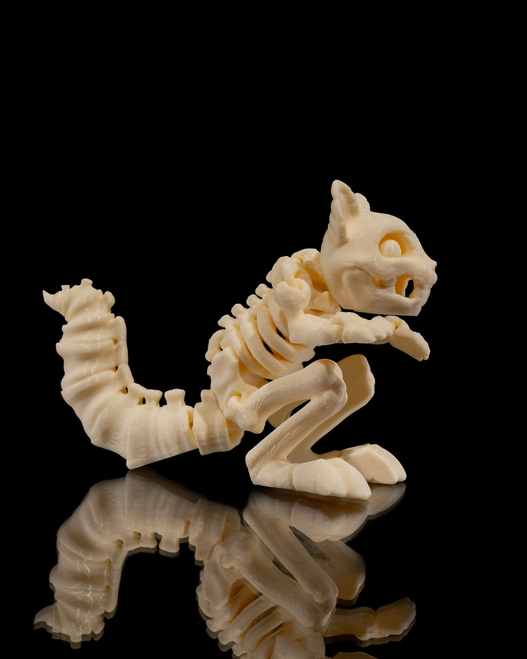 Side profile of Skeleton Fidget Squirrel 3D print in beige PLA showing skeletal details.