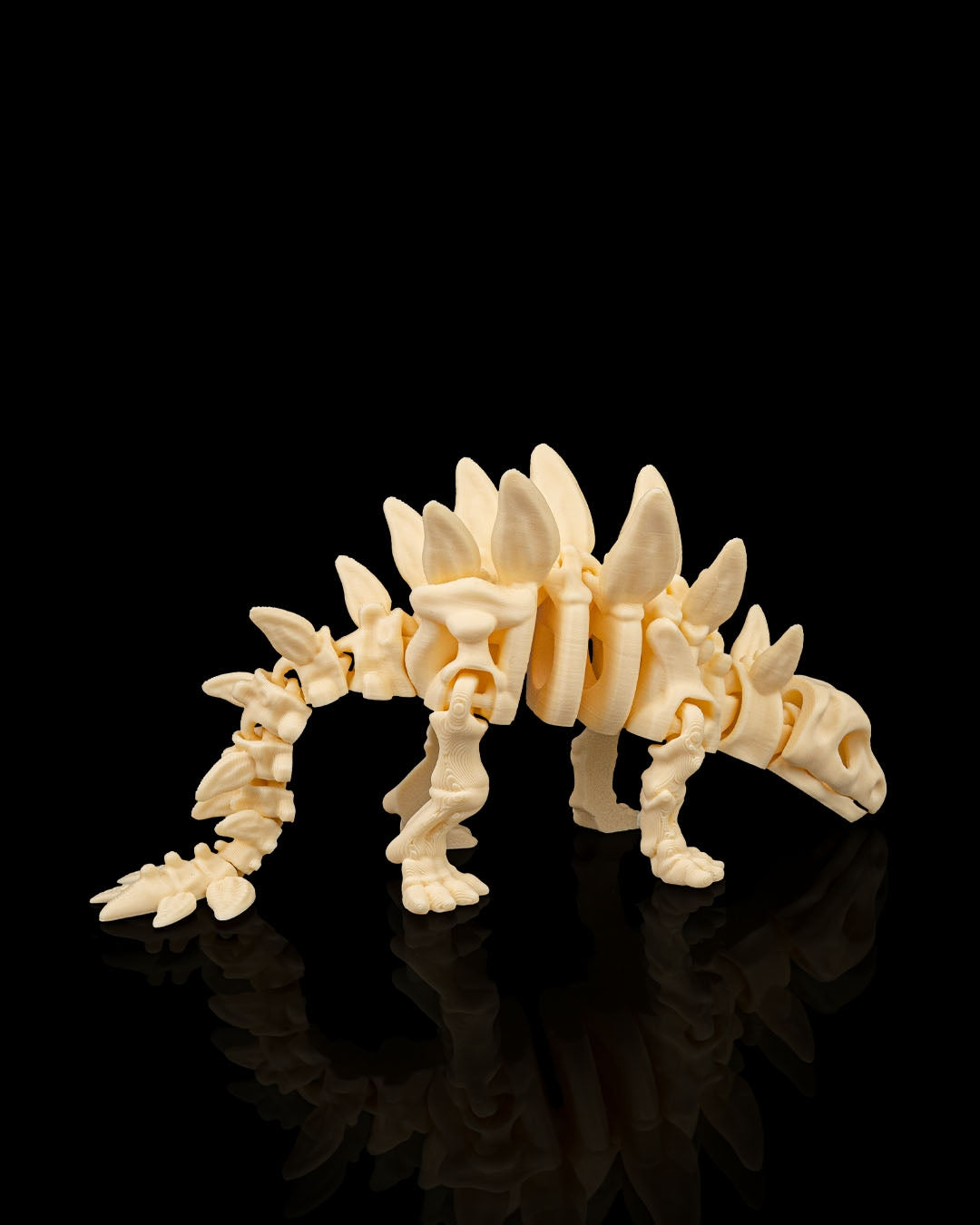 Angled view of 3D printed Skeleton Stegosaurus miniature displaying detailed plates and limbs.