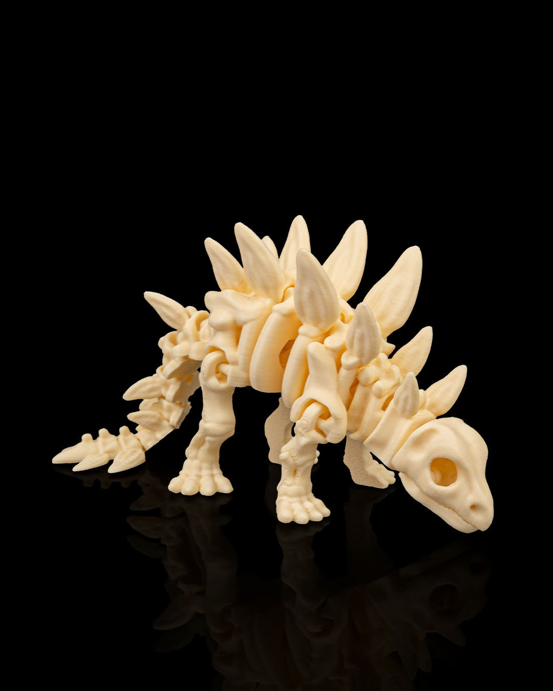 Front angled view of 3D printed Skeleton Stegosaurus miniature displaying detailed plates and limbs.