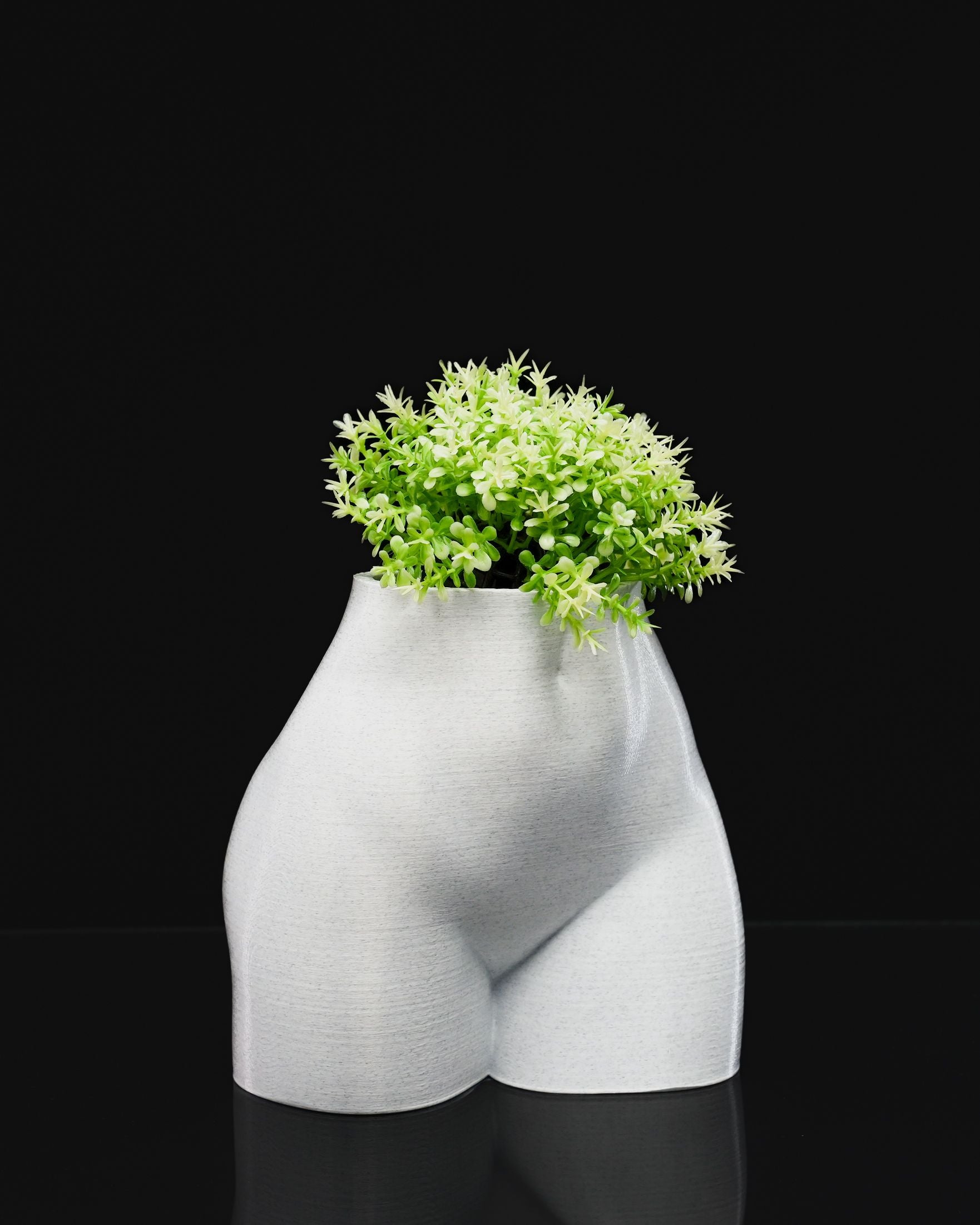 Female Summer Body Vase in PETG holding a plant, showcased on black background.