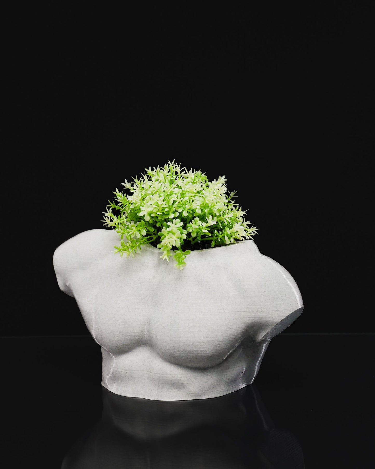 Male Summer Body Vase in white PETG with artificial greenery displayed inside, photographed on black background.