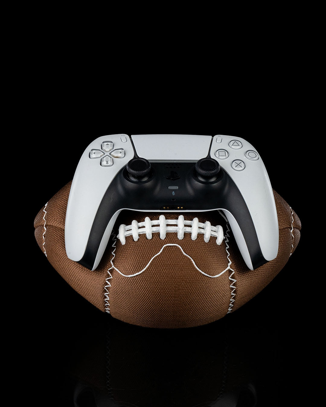 3D-printed football controller holder with Playstation controller resting on top