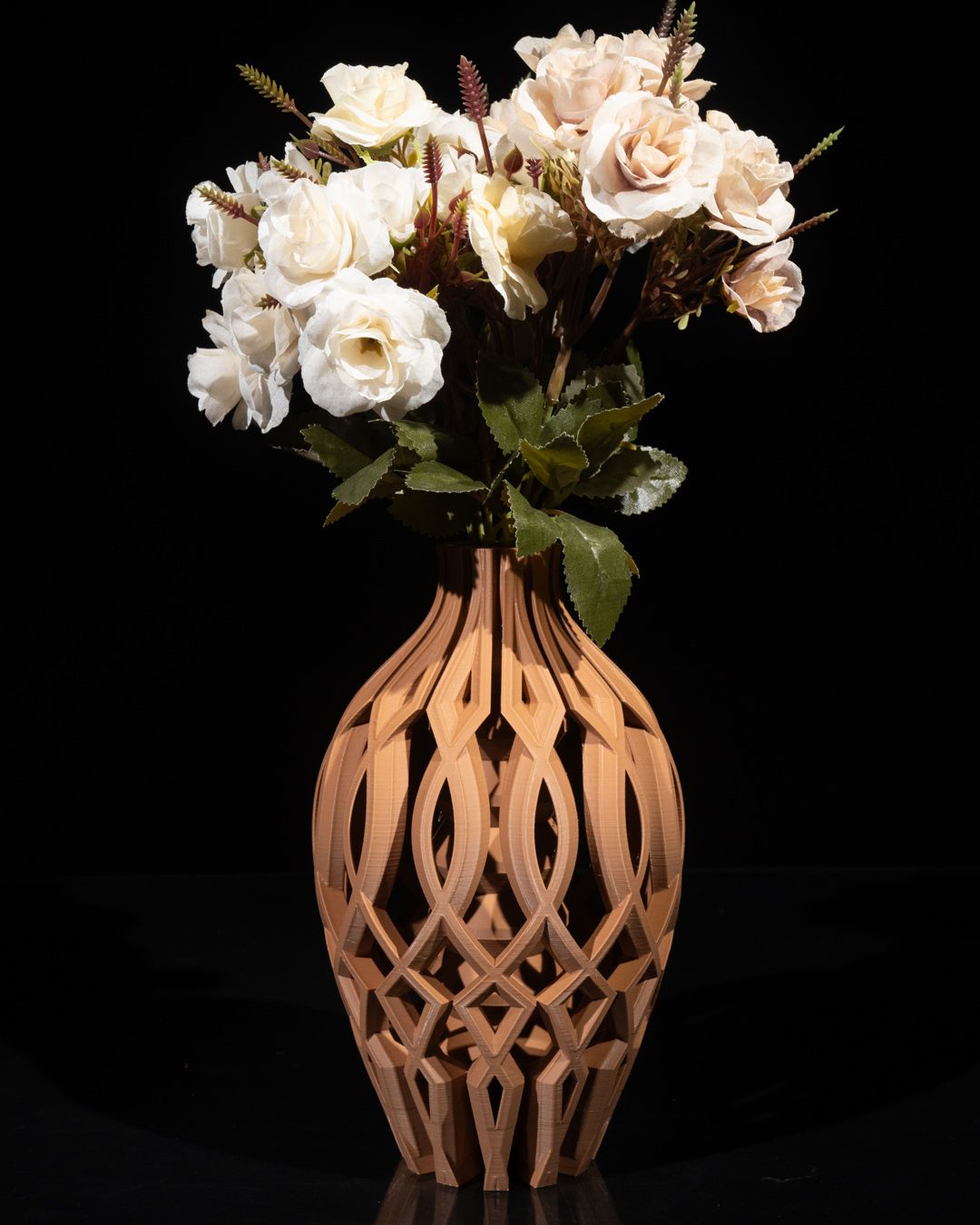 Vista Vase 3D-printed geometric vase holding artificial white flowers on a black background.